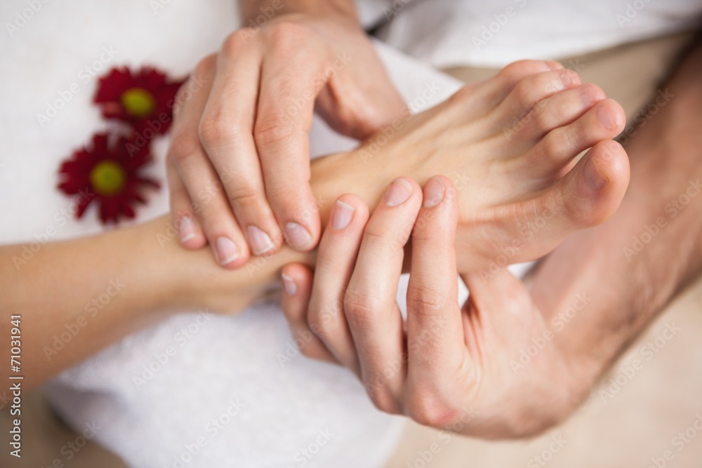 Pedicurist massaging a customers foot Pedicurist massaging a customers foot