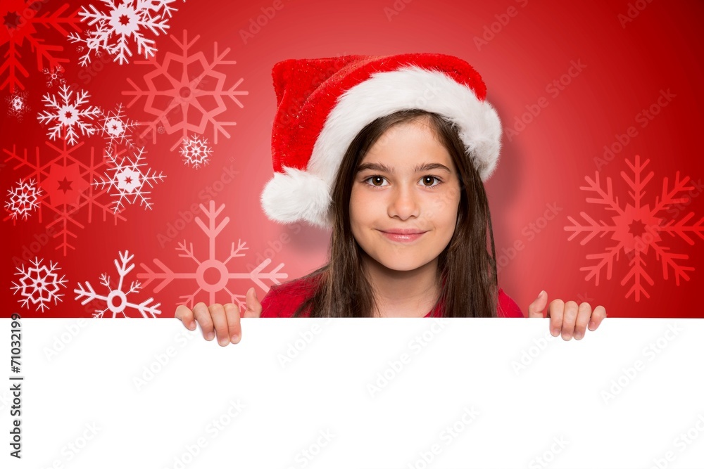 Composite image of festive little girl showing card Composite image of festive little girl showing card