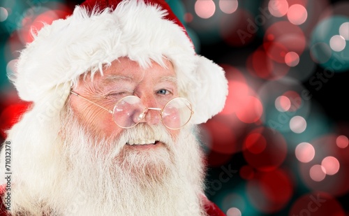 Composite image of santa claus winking