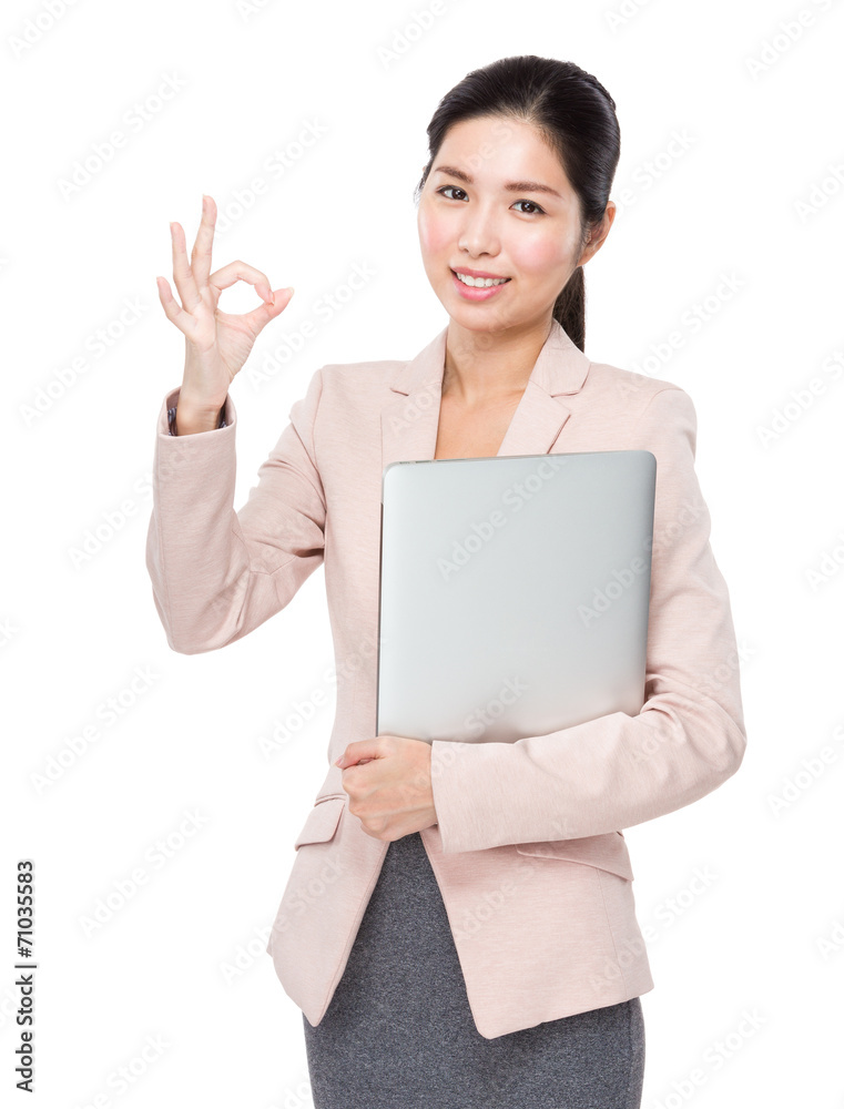 Asian businesswoman with laptop and ok sign Asian businesswoman with laptop and ok sign