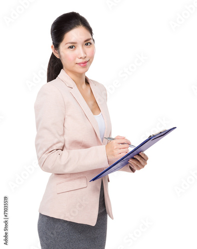 Businesswoman jot note on clipboard © leungchopan