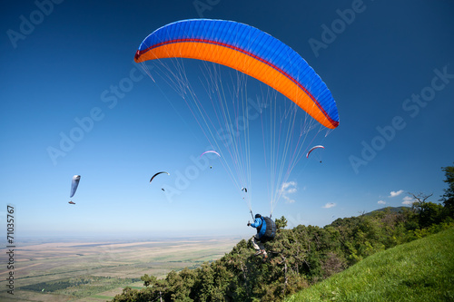 Group of paragliders in flight