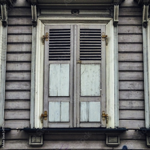 old timber window with closed shutters in riga latvia