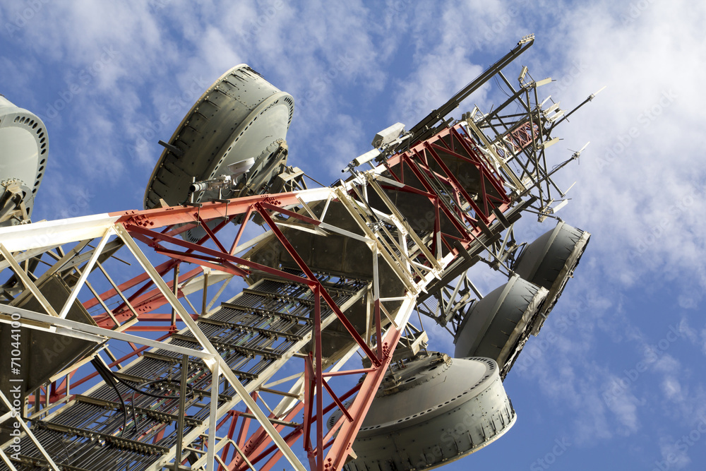 Telecommunications tower against blue sky - obrazy, fototapety, plakaty 