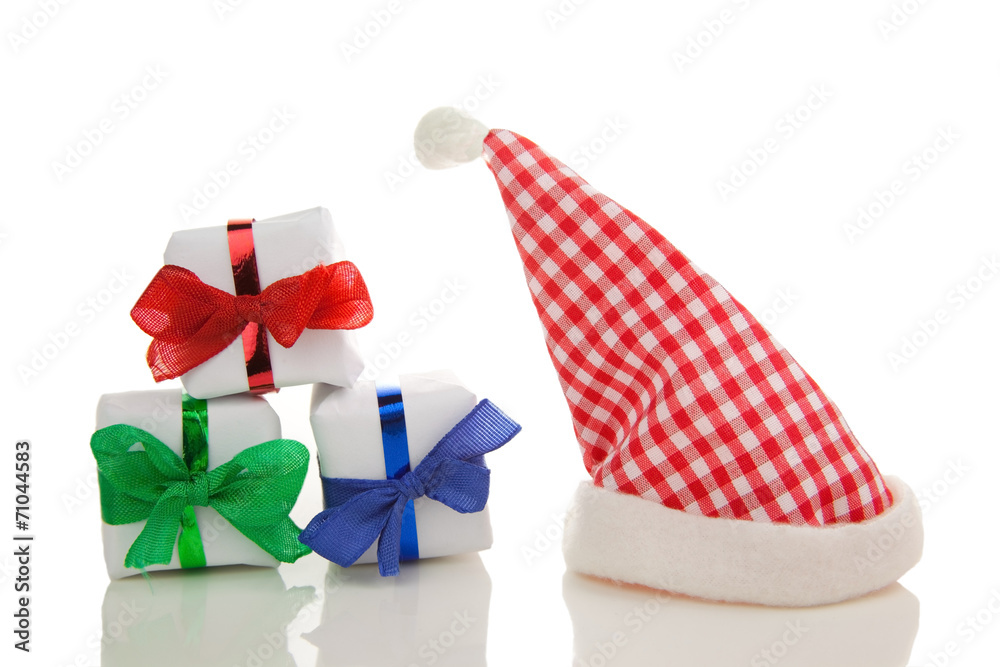 Fototapeta premium three presents with chequered christmas hat isolated
