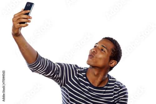 dark-skinned young gay making selfie on white background