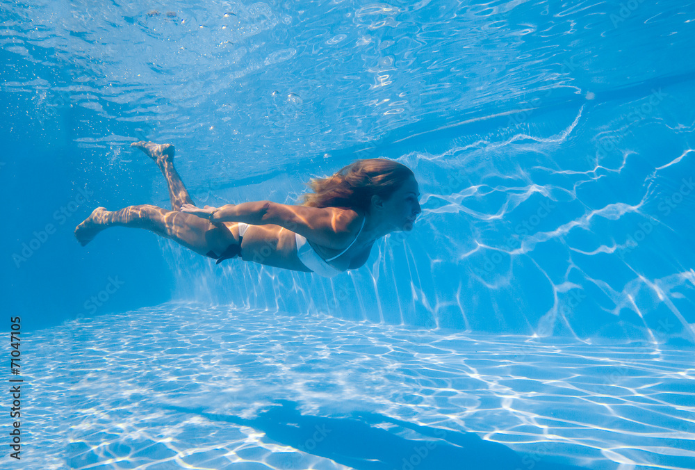 Young woman swimming underwater