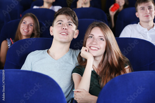 Young couple watching movie...