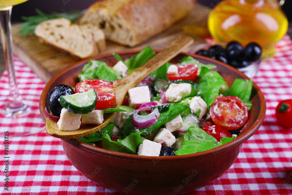 Bowl of Greek salad served with olive oil and bread Bowl of Greek salad served with olive oil and bread