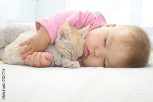 Baby and cat sleeping together