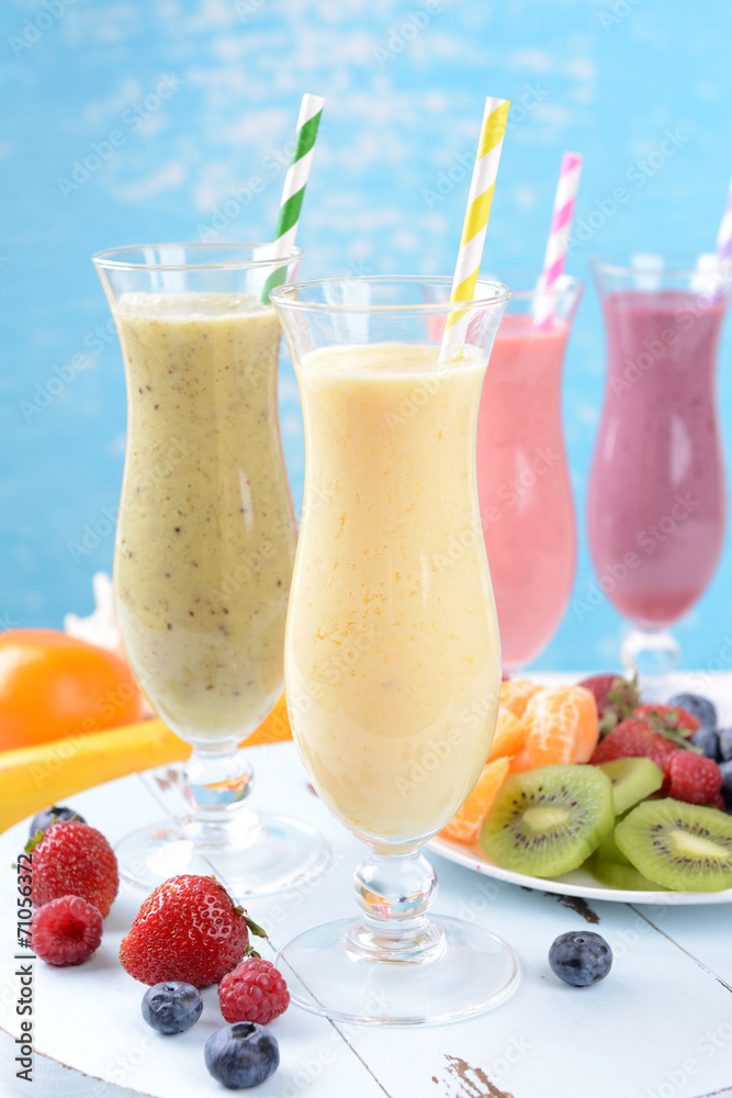 Delicious berry cocktails on table on water background Delicious berry cocktails on table on water background