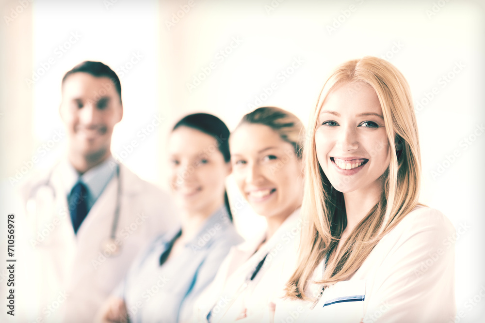 female doctor in front of medical group female doctor in front of medical group