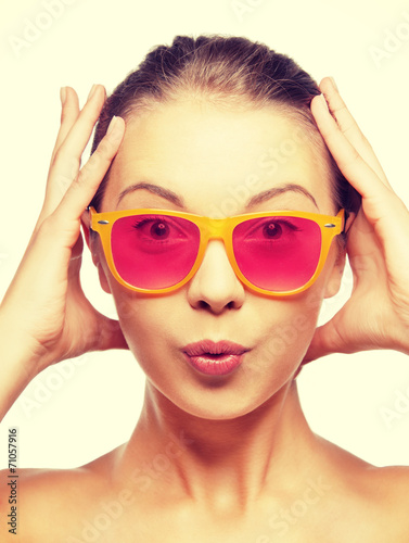 surprised teenage girl in pink sunglasses