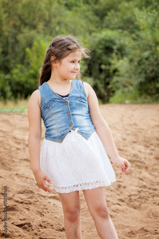 Adorable girl posing in casual clothes on beach Adorable girl posing in casual clothes on beach