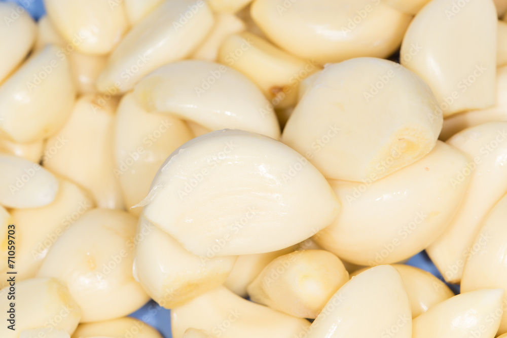 Closeup of peeled cloves of garlic, background