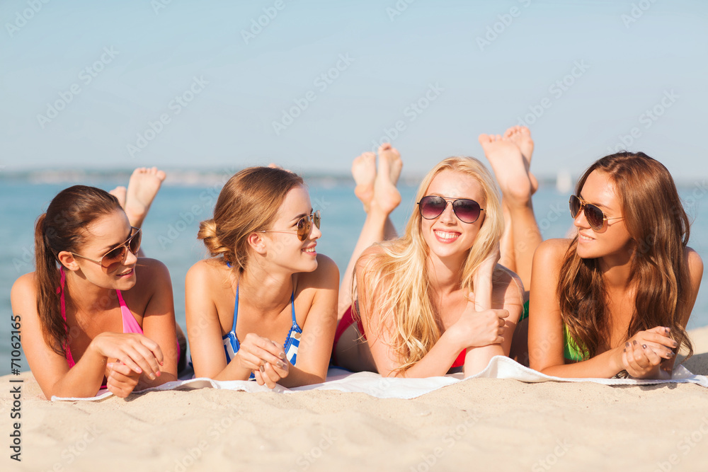 group of smiling women in sunglasses on beach group of smiling women in sunglasses on beach