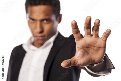 angry african guy showing stop hand