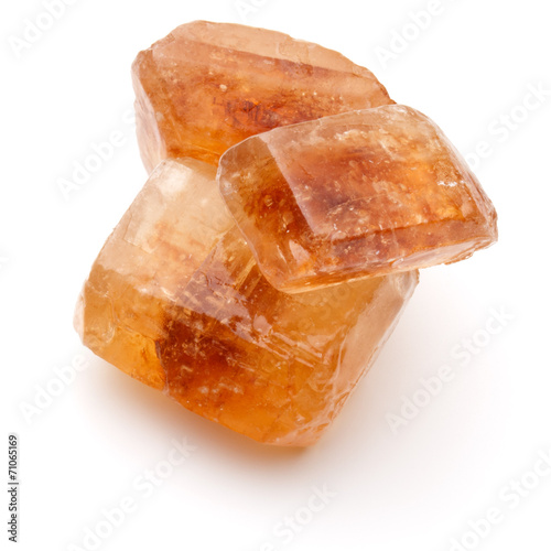 Brown caramelized lump cane sugar cube isolated on white backgro