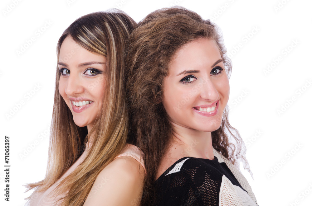 Two female friends isolated on the white Two female friends isolated on the white