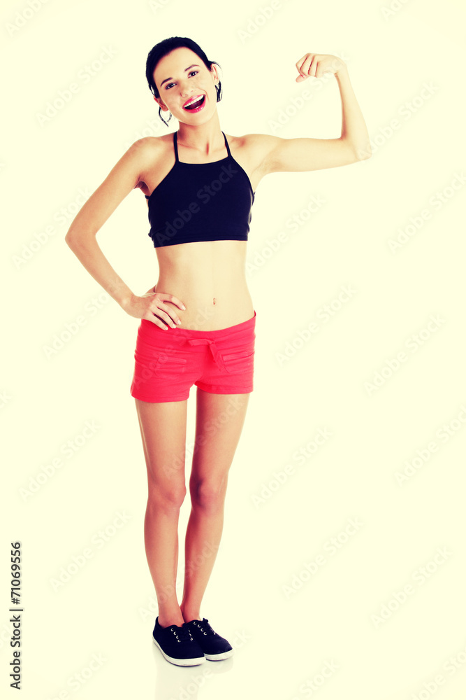 Portrait of beautiful young lady flexing her biceps Portrait of beautiful young lady flexing her biceps