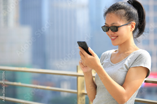 Free Download young woman use cellphone in city  - GFXLoad