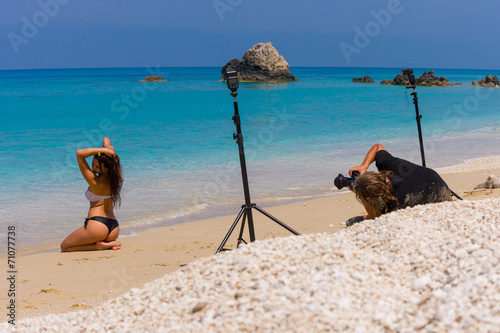 Photoshoot on the beach with beautiful bikini model photo