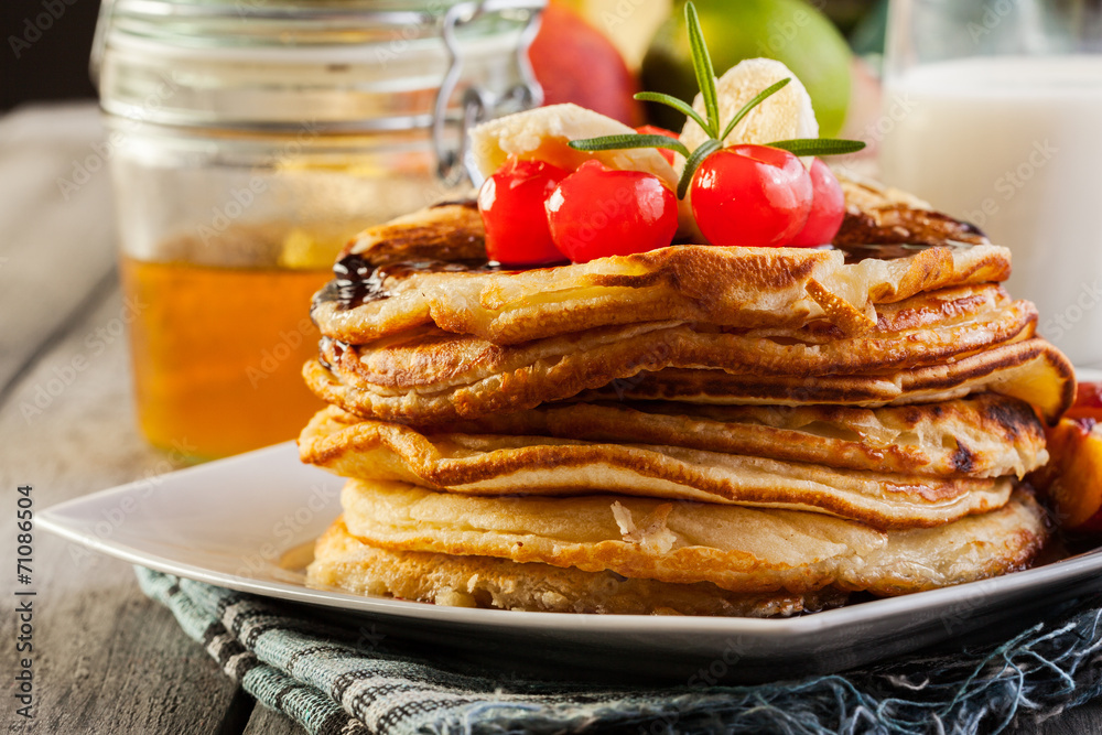 Pancakes with chocolate sauce fruit and glass of milk Pancakes with chocolate sauce fruit and glass of milk