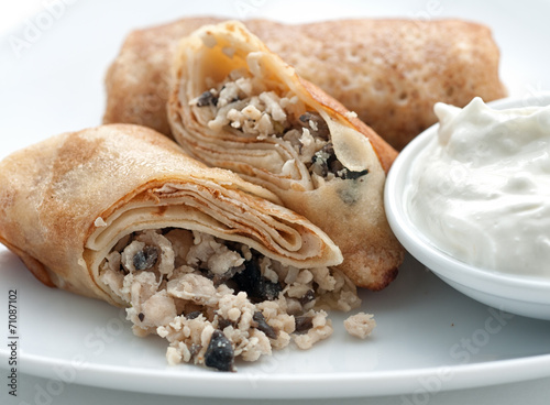 Pancakes filled with minced mushrooms and cottage cheese photo