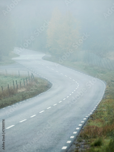 Curvy road in foggy weather