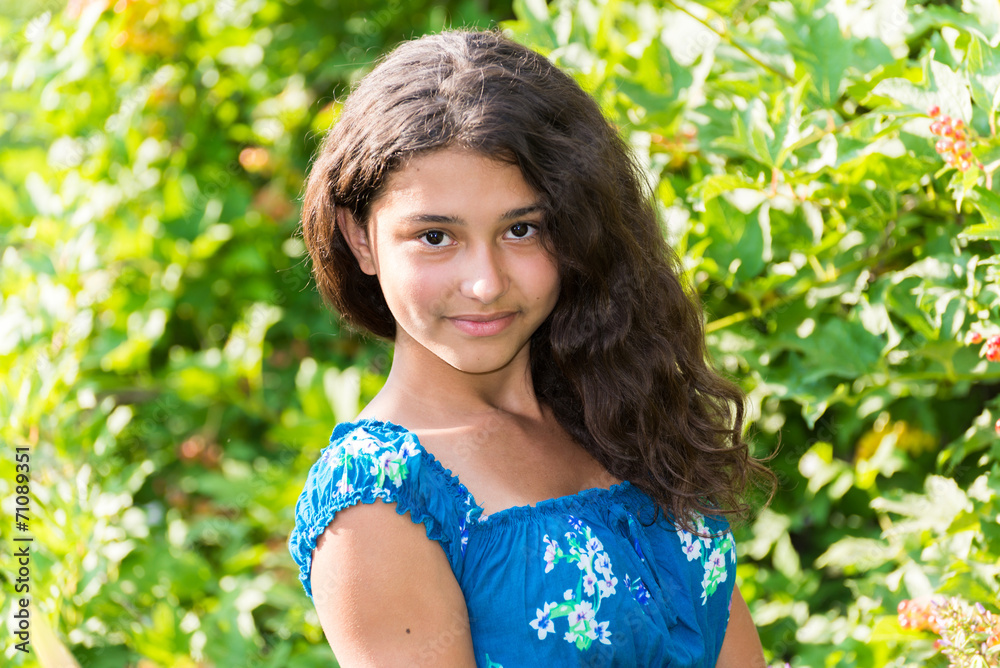 young pretty girl with  curly hair outdoors