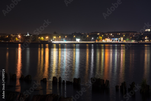 summer night city light reflections over water © Martins Vanags