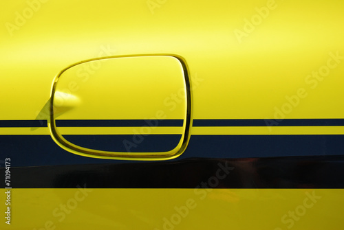 Yellow vehicle fuel filler cap closeup detail