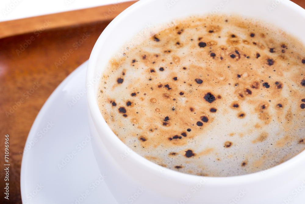 Obraz premium Cup of coffee on a wooden