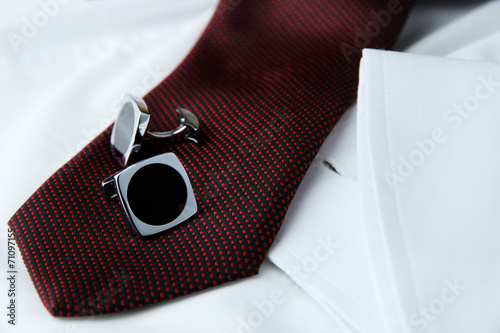 Billede på lærred A pair of cuff links on a brown cravat on the white shirt