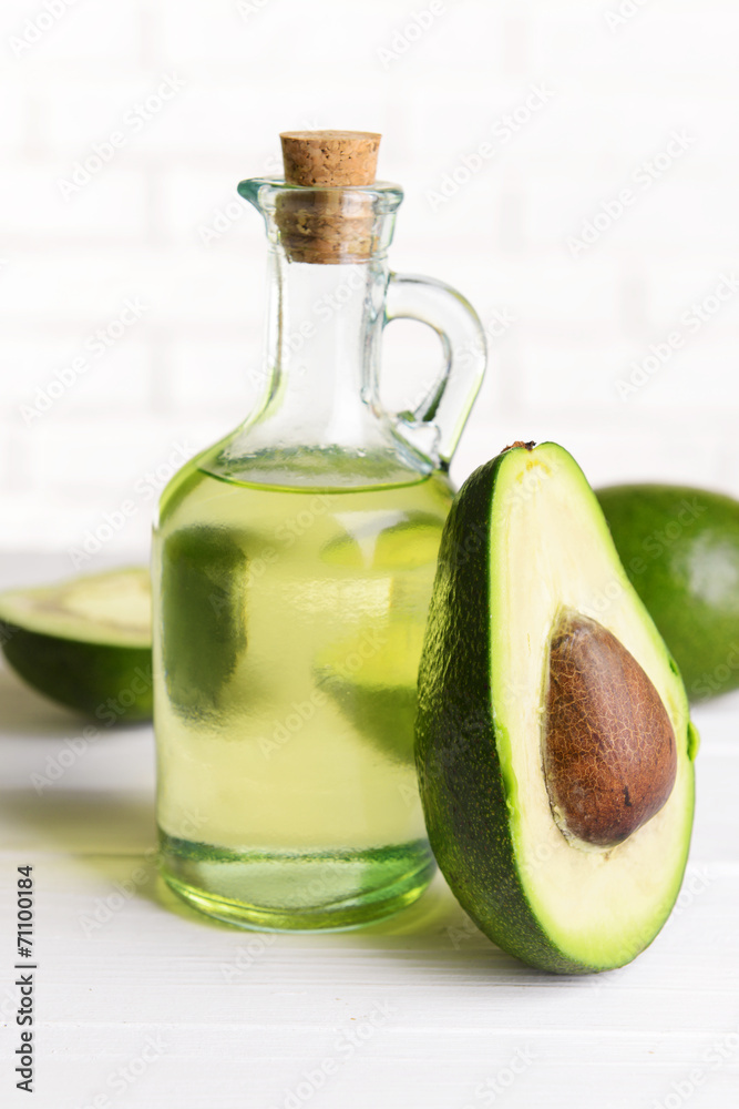 Avocado oil on table on light background Avocado oil on table on light background