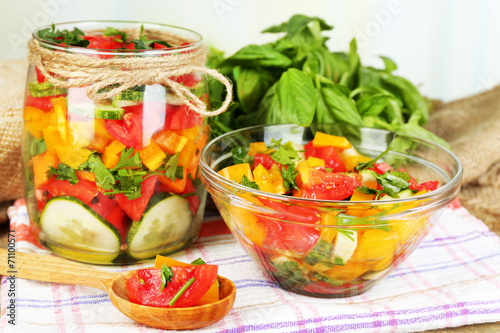 Vegetable salad in glass jar and bowl
