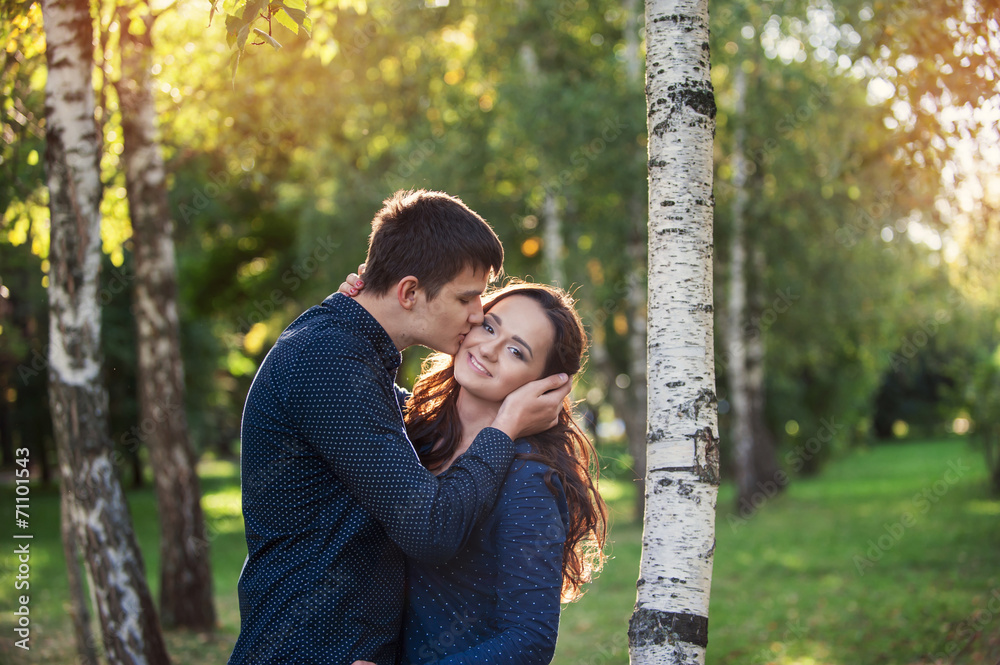 Outdoor happy couple in love posing in cold winter weather. Youn Outdoor happy couple in love posing in cold winter weather. Youn