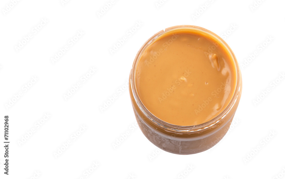 Peanut butter in a jar over white background Peanut butter in a jar over white background