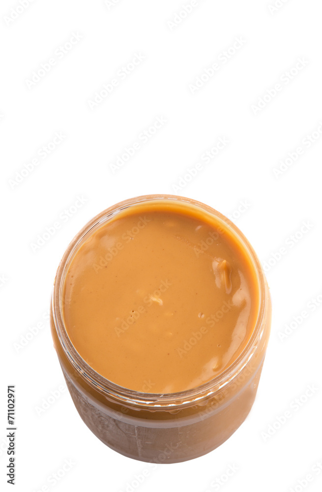 Peanut butter in a jar over white background