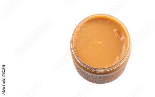 Peanut butter in a jar over white background