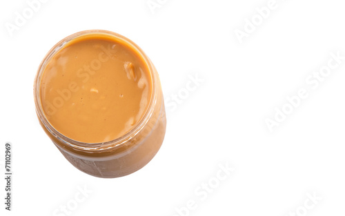 Peanut butter in a jar over white background