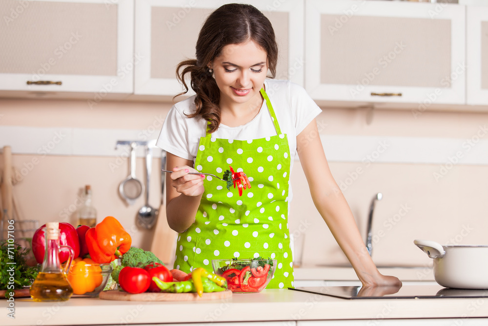 Young Woman Cooking in the kitchen. Healthy Food. Dieting Concep Young Woman Cooking in the kitchen. Healthy Food. Dieting Concep