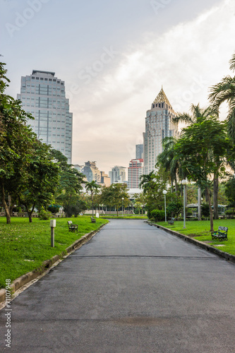 Pathway in the park with modern building © dearzdearzz