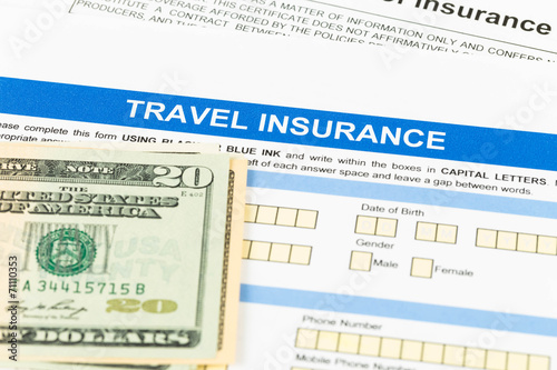 Travel insurance application form with dollar banknote