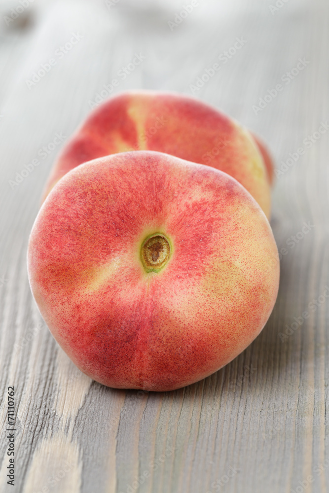 flat peaches on wood table