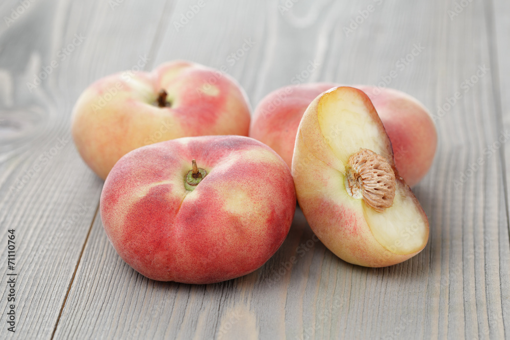flat peaches on wood table