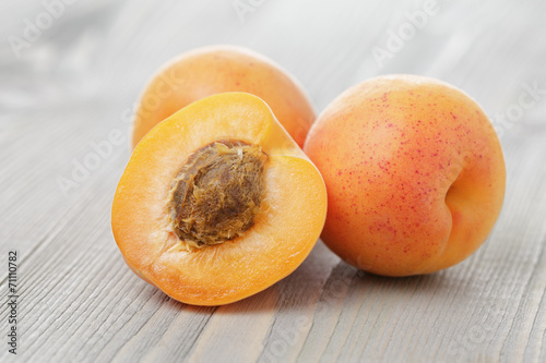 ripe juicy apricots on wooden table