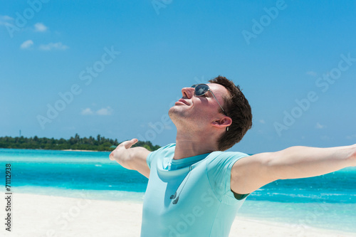 Man relaxing at beach enjoying summer freedom