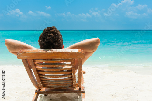 Young man resting on beach