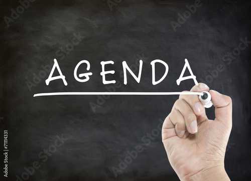 agenda with hand writing on blackboard
